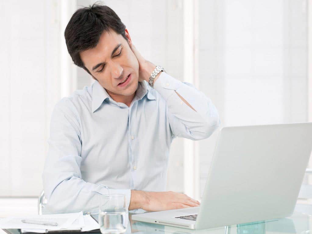 Man with neck pain while working