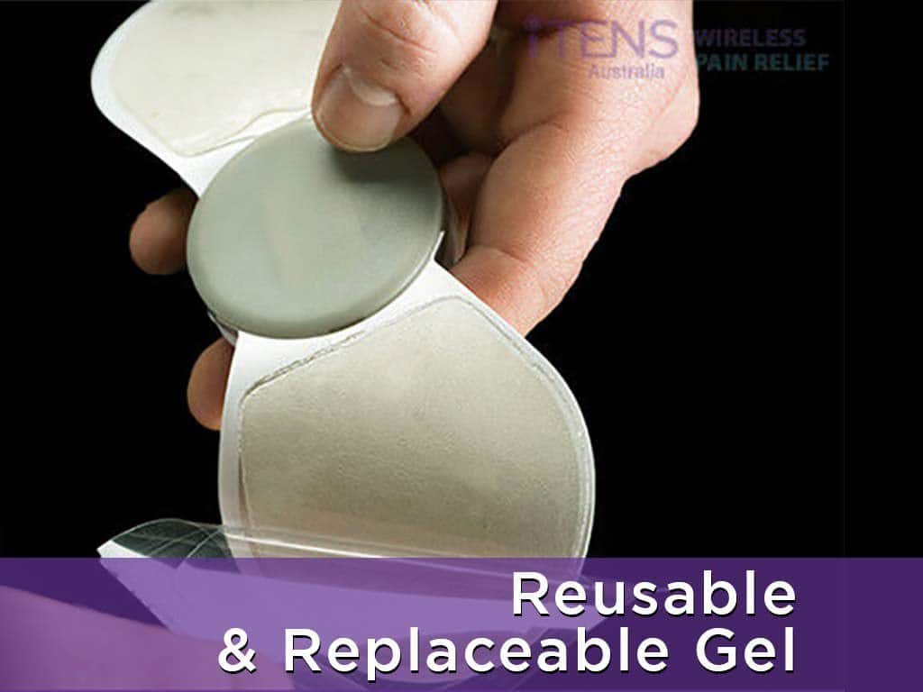 A hand removing the cover of a TENS adhesive pad