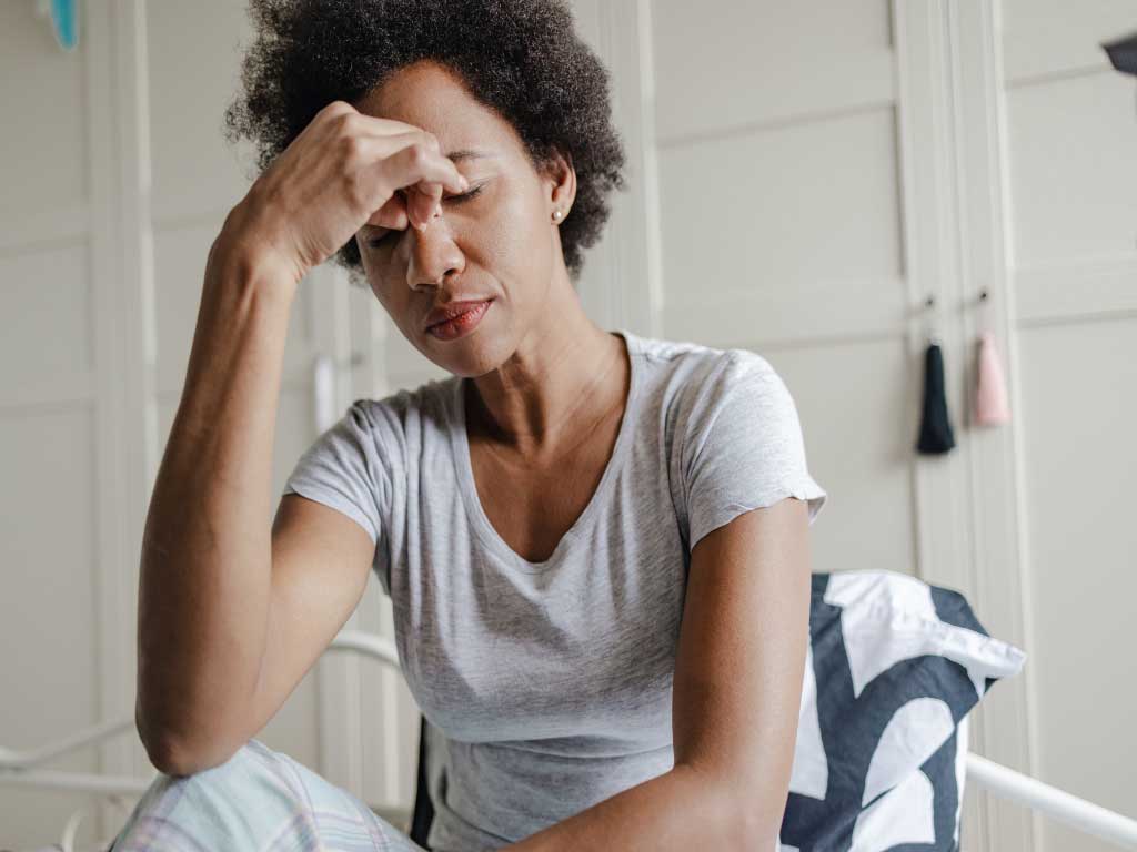 A woman experiencing headache.