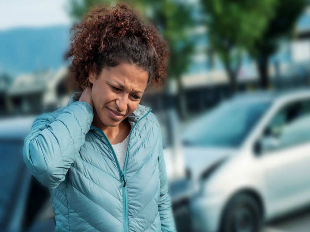 A woman experiencing pain while walking outside
