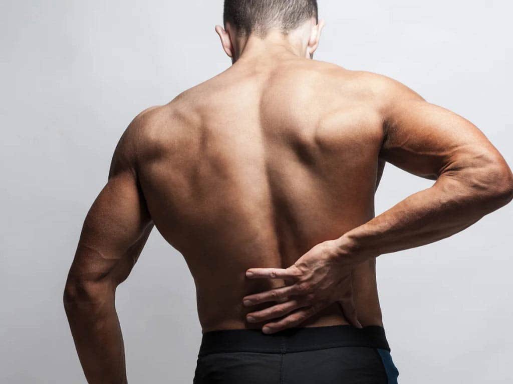 A man touching his lower back