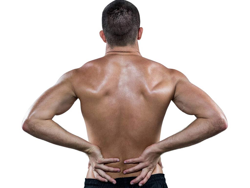 A man holding his lower back with both hands