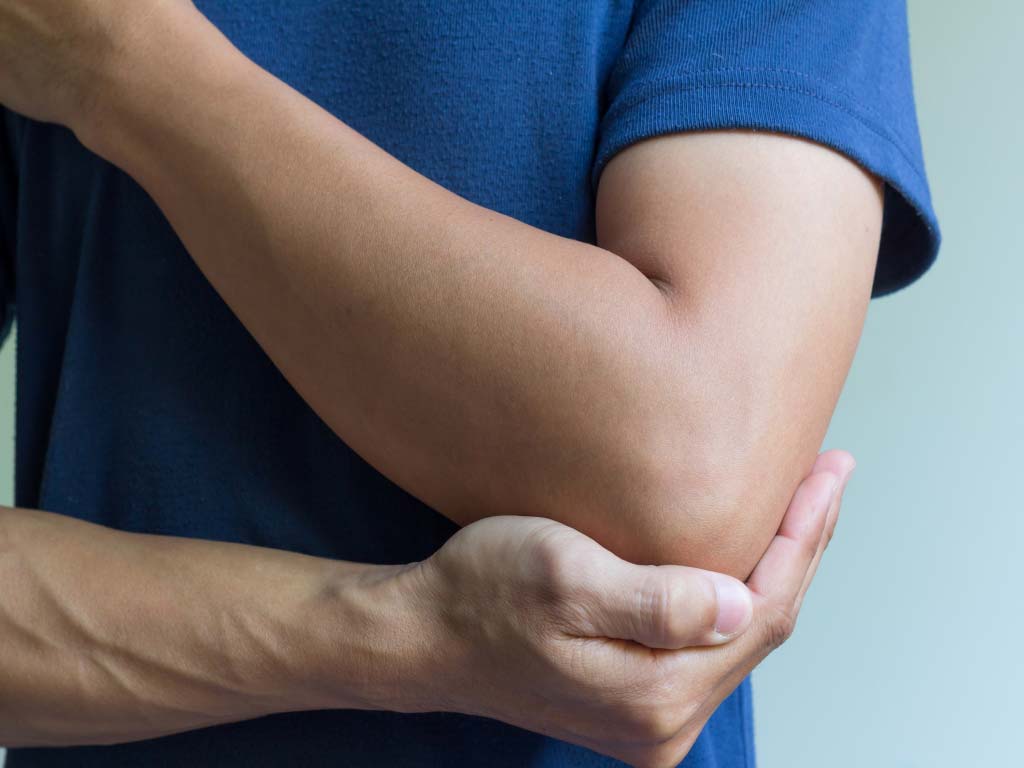 A person holding their elbow due to pain