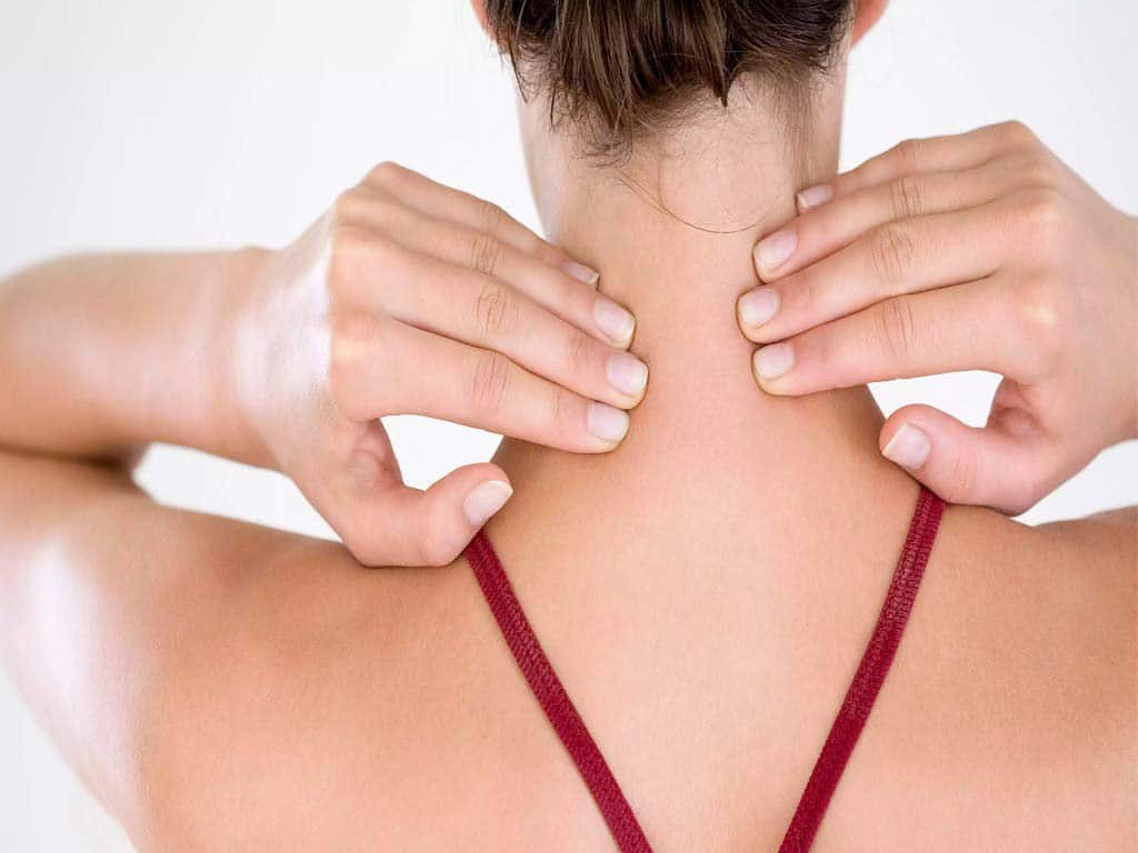 Woman placing her hands on the back of her neck