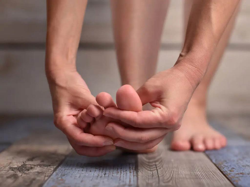 A person holding their foot with both hands