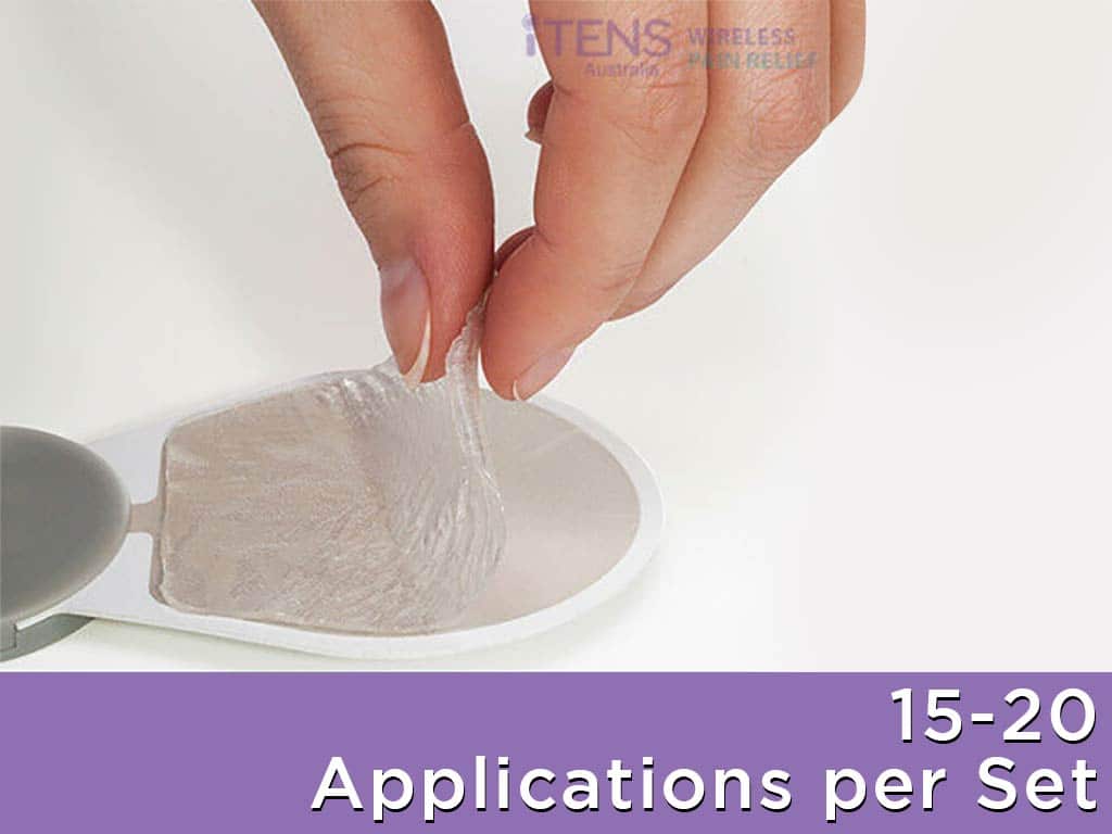 A hand peeling off the plastic backing of the iTENS gel pad