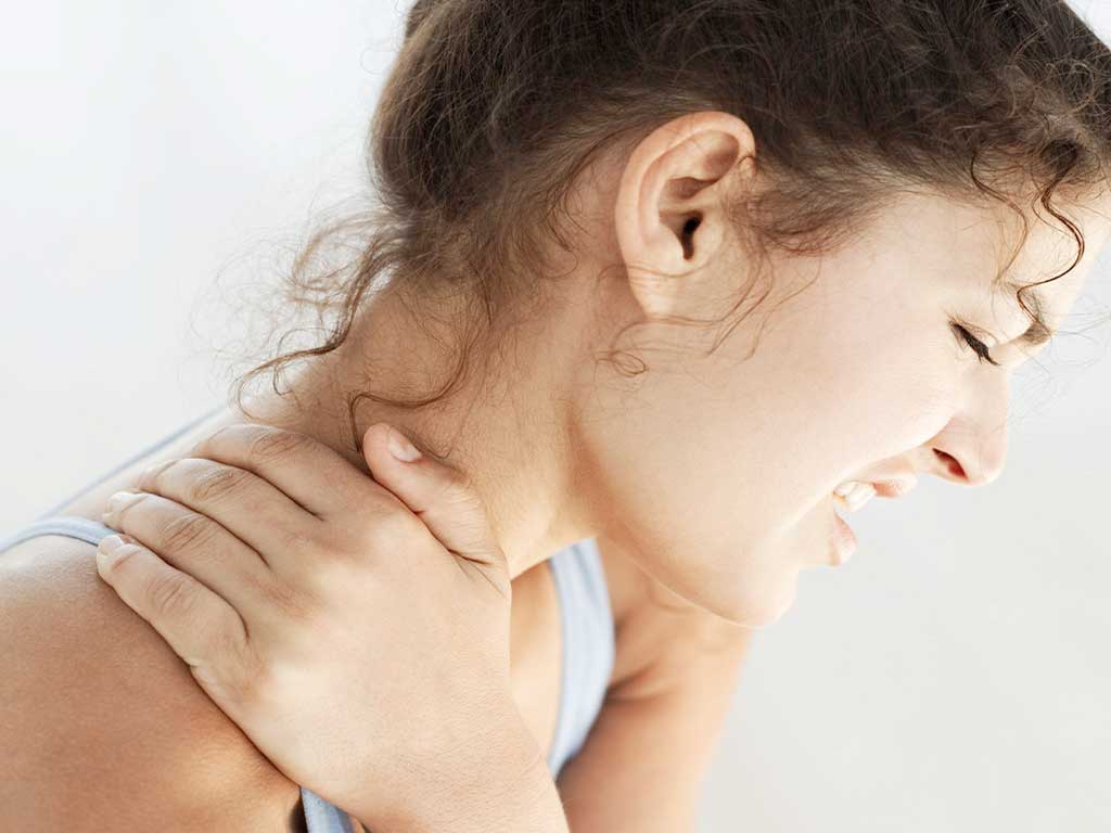A woman experiencing intense neck pain