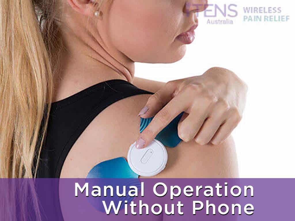 A woman pressing a button on the wireless TENS machine on her shoulder